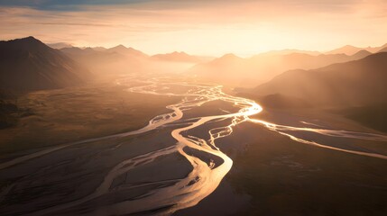 Golden sunset illuminates braided river winding through vast serene landscape vista