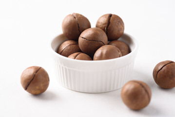 Fresh organic macadamia nuts on white background