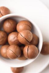 Fresh organic macadamia nuts on white background
