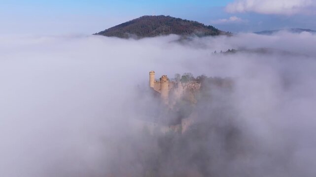 Aerial view of Auerbach Castle emerging majestically from a sea of fog, creating a surreal and ethereal landscape, Bensheim, Hessen, Germany.