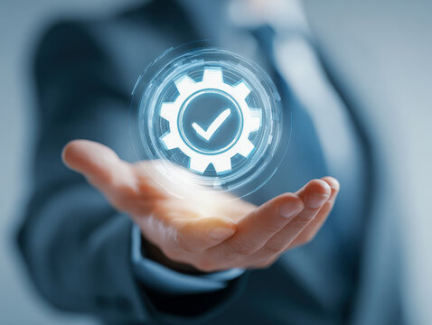 Businessman holding a digital gear icon with a check mark symbolizing quality assurance and successful process management in a futuristic interface design