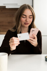 Internet banking and E-commerce concept. Mobile shopping concept. Woman using smartphone shopping online at home.