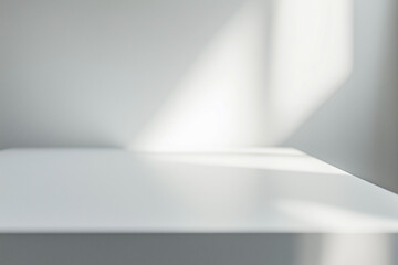 Close-up of a clean, minimalist white table surface, empty space for products
