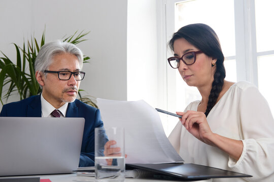 Business people collaborating on documents during office meeting