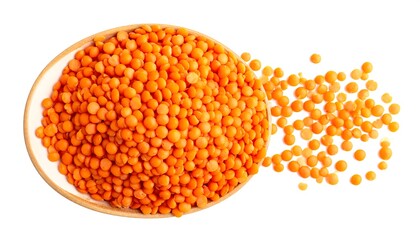 Overhead shot of orange lentils in a bowl with some spilled out against a clean white backdrop