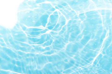 Blue water with ripples on the surface. Defocus blurred transparent blue colored clear calm water surface texture with splashes and bubbles. Water waves with shining pattern texture background.