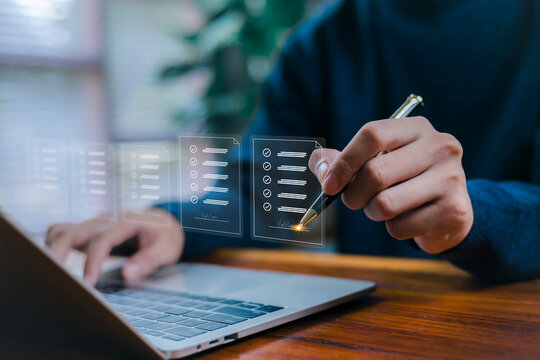 A person digitally signing a smart contract using a pen on a laptop, showcasing blockchain agreement technology, secure digital authorization, automated document management in a modern tech workspace.