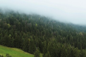 Misty hills and valley with rural houses and farmland