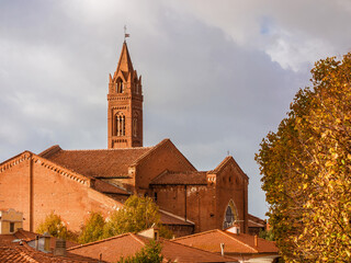 San Francesco (St Francis) 13th centuty medieval church with beautiful hanging bell tower in Pisa, with autumnal leaves