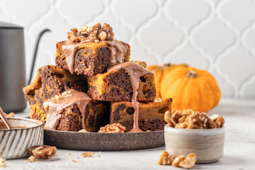 Homemade chocolate brownie cake dessert with pumpkin puree and spices on a plate white table background. Baking Thanksgiving Day or Halloween