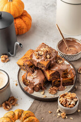 Homemade chocolate brownie cake dessert with pumpkin puree and spices on a plate white table background. Baking Thanksgiving Day or Halloween