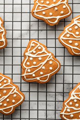 Freshly Baked gingerbread Christmas Cookies shaped like trees on Cooling Rack close up. Christmas baking, top view