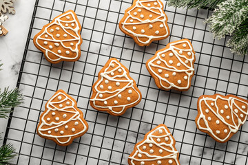Freshly Baked gingerbread Christmas Cookies shaped like trees on Cooling Rack. Christmas baking, top view