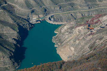 Turquoise expanse amidst cliffs: canyon reservoir
