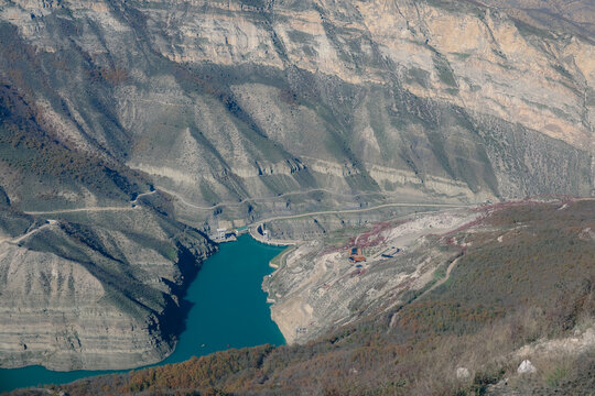 Turquoise expanse amidst cliffs: canyon reservoir