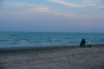 Solitude by the shore: contemplation at sunset