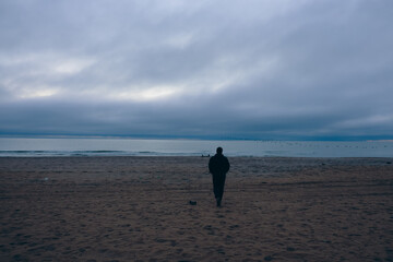 Reflections by the sea: silhouette against the clouds