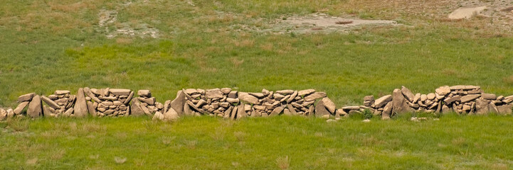 Green field with pre celtic wall built of big rocks. Montalegre, Portugal 