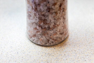Chunky pink salt in a plastic bottle