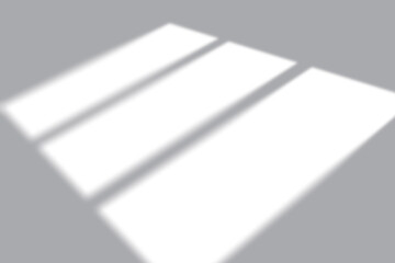 Soft window light casting geometric shadows across a clean, minimalist backdrop for product placement.