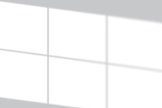 Soft window light creates a serene grid shadow overlay on a clean white background, perfect for modern design.