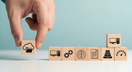Hand placing a cloud computing icon block in a sequence of technology and business icons