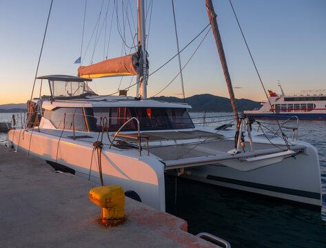 Catamaran and yacht at sunset at Loutra Edipsou port on Evia Island in Greece