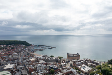 Aerial drone photo of the town centre of Scarborough North Yorkshire in the UK, showing the residential housing estates and historical town houses by the seaside going along to the beach front
