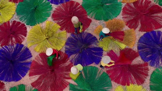 Aerial view of vibrant fiber circles spread out to dry under the sun with workers wearing conical hats, Ho Chi Minh City, Ho Chi Minh City, Vietnam.