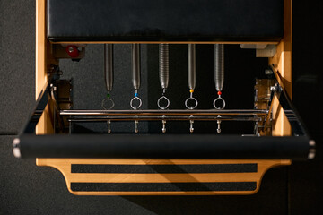 Close up of reformer exercise machine at Pilates studio.