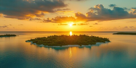 Fototapeta premium A stunning sunset over a small island with a lush green forest, surrounded by calm waters and a clear sky with scattered clouds.