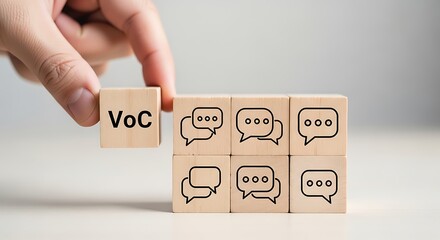 Hand placing a voc voice of the customer block next to speech bubble blocks, symbolizing feedback and communication