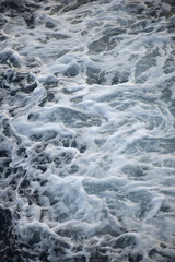 The beach foam in the sea is pure like silk