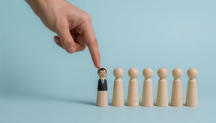 hand selecting a figurine from a group, representing the concept of choice, selection, or leadership