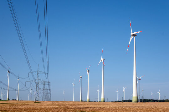 Electricity pylons with power lines and wind energy plants seen in Germany