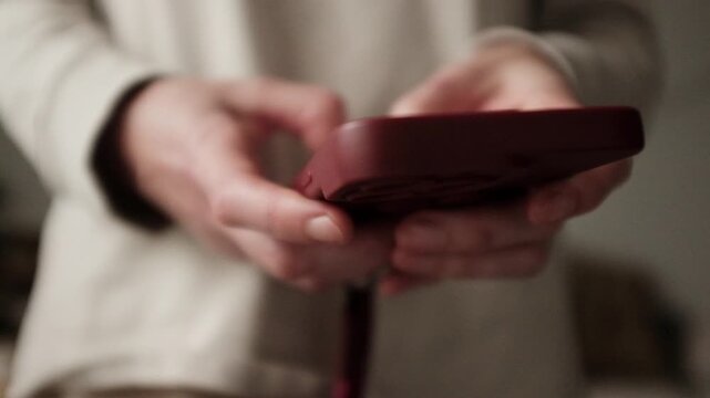 Closeup video of a young woman doom scrolling a smartphone. Addictive behaviour. Modern world problem. Social media marketing. Working through smartphone.