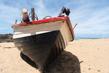 View of rustic fishing boats on Rio Vermelho Beach in front of the urban horizon. City of Salvador,...