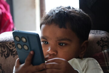 Child's Eyes Focused on Smartphone Screen. Intense Digital Addiction and Modern Screen Time.