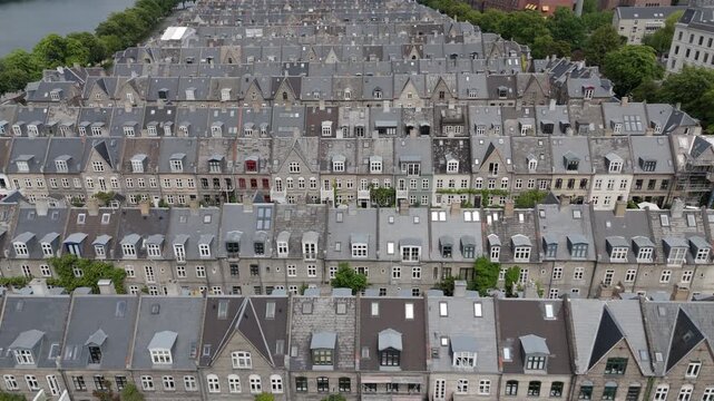 Aerial view flying over the Potato Rows, a historic residential area in Copenhagen, Denmark, known for its distinctive rows of 19th-century terraced houses.	
