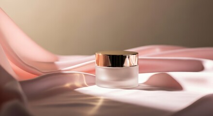 Close up of a cosmetic jar with golden lid on a pink satin fabric