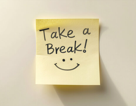 Yellow sticky note with handwritten “Take a Break!” text and smiley face, placed on a light surface with soft shadows. Motivational reminder for work, study, or productivity scenes.