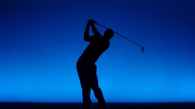 A dedicated golfer swings an iron club skillfully, silhouetted against a deep blue backdrop. The scene evokes a sense of calm and focus, perfect for an evening practice session