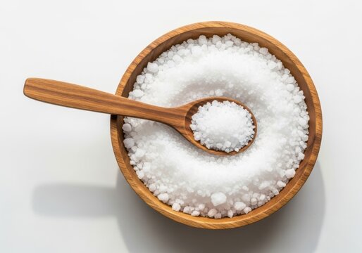 Wooden bowl filled with coarse sea salt and spoon isolated on off white background - Powered by Adobe