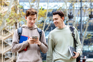 Young college students checking a smartphone on university campus