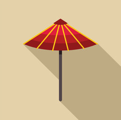 Red japanese umbrella with yellow decorations casting a long shadow on a sunny day