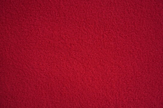 red fleece fabric texture, macro texture fleece orange fabric photo above as background	
