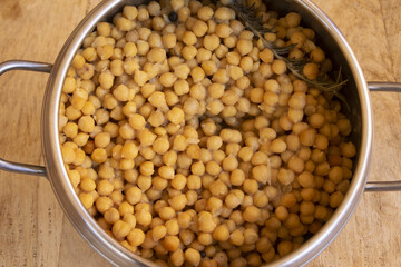 cooked chickpeas with rosemary in stainless steel pressure cooker pot