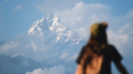 Rear view blurred of a woman traveler looking at Machapuchare peak, Annapurna mountain range in...
