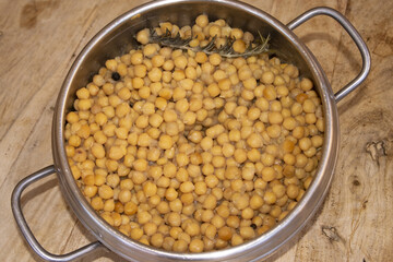 cooked chickpeas with rosemary in stainless steel pressure cooker pot