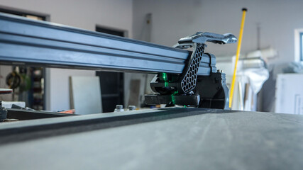 Close-up view of a professional tile cutter in a workshop setting